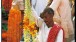 Flower seller at Varanasi with handmade garland of Jasime and marigold flowers ti be used in a wedding ceremony