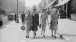 Four women walk down street in Utility clothing © IWM
