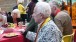 Wilfred sitting among some of his many guests. Everyone wore a medallion with either a red (friend) or yellow (family) ribbon - Wilfred Cass wore both