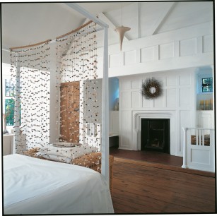 All too often, bedroom fireplaces were among the earliest victims of renovation or modernization, but they survive at Houghton, and have been carefully restored. The white-painted panelling around this one is reminiscent of rooms in Morris' Red House