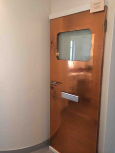 Isokon Cabinet Door: The Pritchards’ copper faced plywood front door. Photograph © Stephen Kingsley