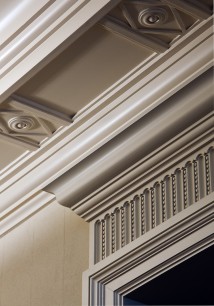 A stylized plaster modillion (projecting bracket) with a fluted and beaded overdoor detail. John B Murray Architect