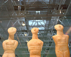 Cycladic figures. The early bronze age (Early Cyclades) marble figures from Greek islands that lie between Athens and Crete set against the Hi-Tech architecture.