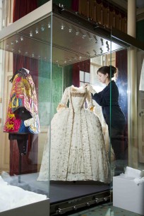 Conservator prepares a sack-back dress for display in the State Apartments