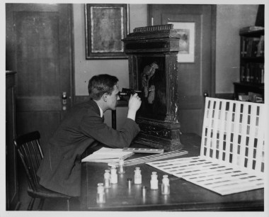 A conservator studying a painting