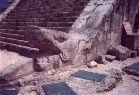 The serpent head at the bottom of the column on the temple of kukulcan taken May 1997, Chichén Itzá, Yucatan