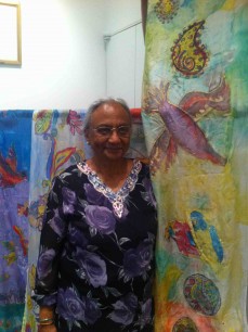 Jyoti Patel with a silk wall hanging she created for Journeys East