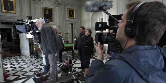 Mike Leigh directs cast and film crew in the Great Hall, Petworrh Houae