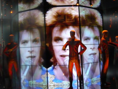 Jumpsuit worn for Top of the Pops (BBC) performance of Starman, shown against video of same broadcast