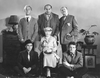 The Ladykillers (1955) studio publicity portrait criminal mastermind Professor Marcus (Alec Guinness) and his gang (Danny Green, Cecil Parker, Herbert Lom and Peter Sellers with Mrs Wilberforce (Katie Johnson), all dressed in character