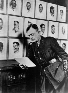 Professor Henry Tonks at Queen's Hospital, Sidcup, Kent,  in front of some of his pastel paintings of soldiers with disfiguring facial wounds. © Dr Andrew Bamji, Gillies Archivist, BAPRAS