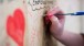 A member of the public leaves a message on the 'Riot wall'