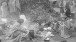 The Liberation of Bergen-Belsen Concentration Camp, April 1945. Women inmates prepare food in the open air, using the boots of the dead (piled up in the background) as fuel for their fires.