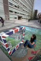 A spectator enjoys the 3D pavement art by 3D Joe and Max