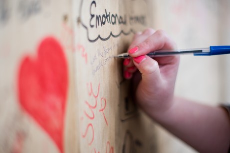 A member of the public leaves a message on the 'Riot wall'