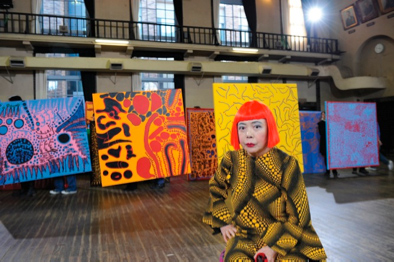 Yayoi Kusama with her latest paintings at Tokyo 2011, Musashi University, Tokyo. Collection Yayoi Kusama. Image courtesy Yayoi Kusama Studio Inc.; Ota Fine Arts, Tokyo; Victoria Miro Gallery, London; and Gagosian Gallery New Yor